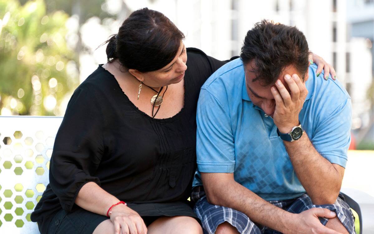 A woman comforting her husband.