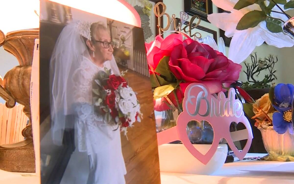 A table in Fideli's room now that has a photo of her in her wedding dress and multiple 'bride' decor items.