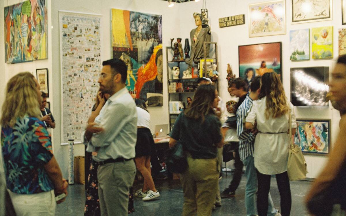 People walking around an art gallery.
