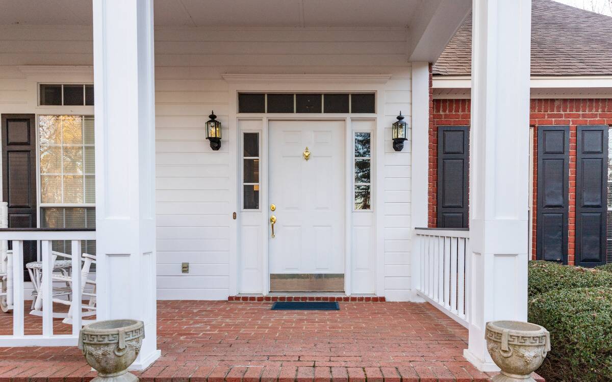 The front door and porch of a suburban home.