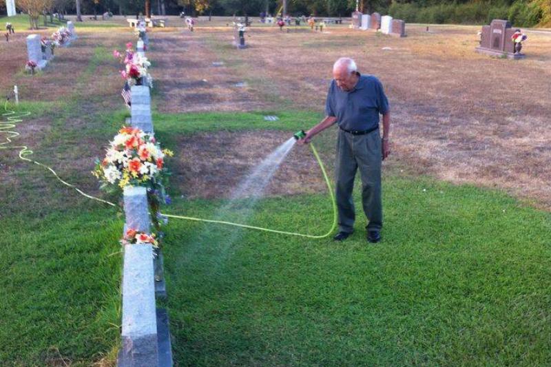 Jake watering his wife's plot.