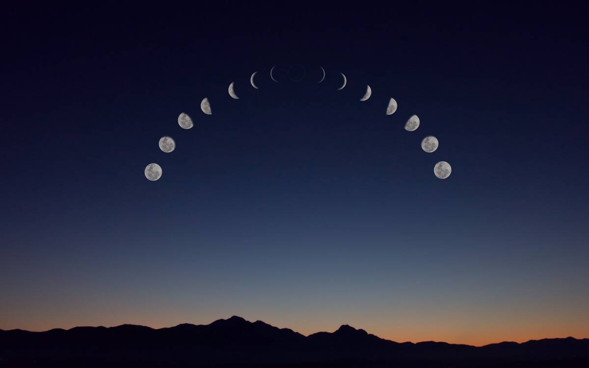 All the phases of the moon in an arch in the sky.
