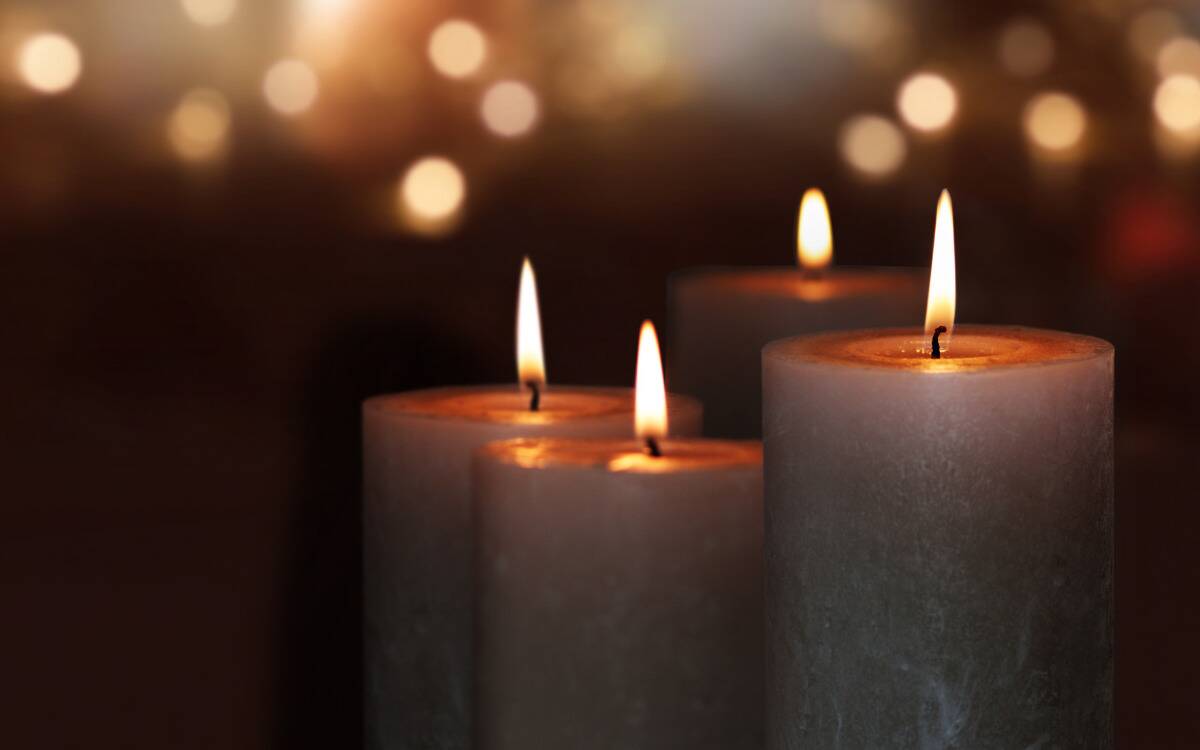 Tall pillar candles with lit wicks.