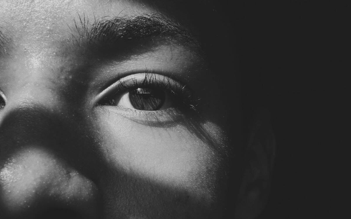 A greyscale closeup of someone's eye.
