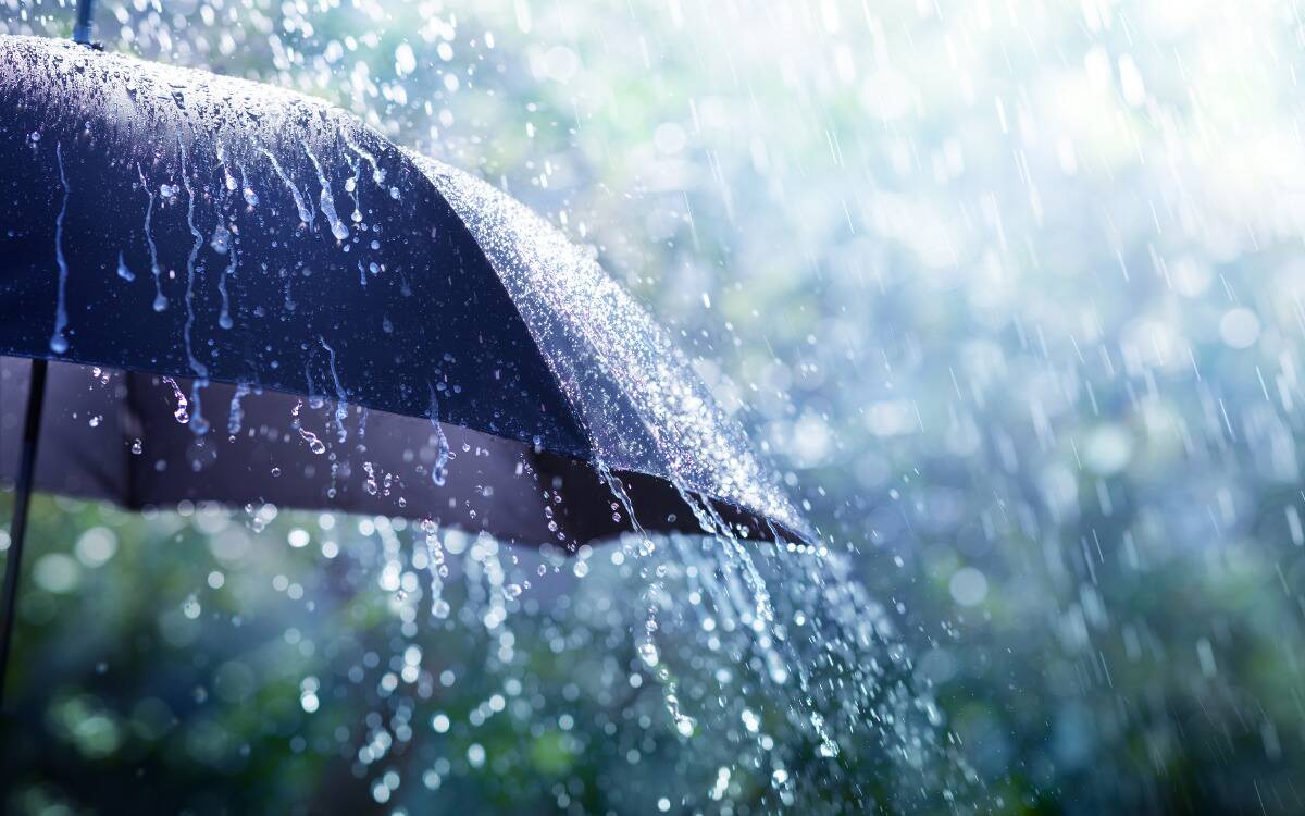 Rain falling on an umbrella.