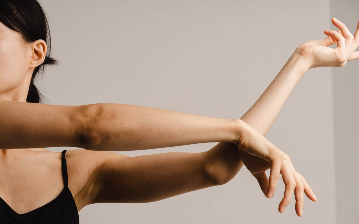 A woman stretching both her arms to the side.