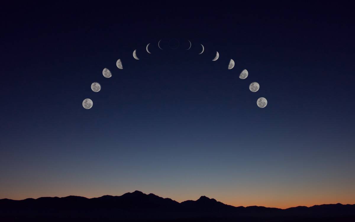 A photo of the sky with an arched display of all the moon phases.