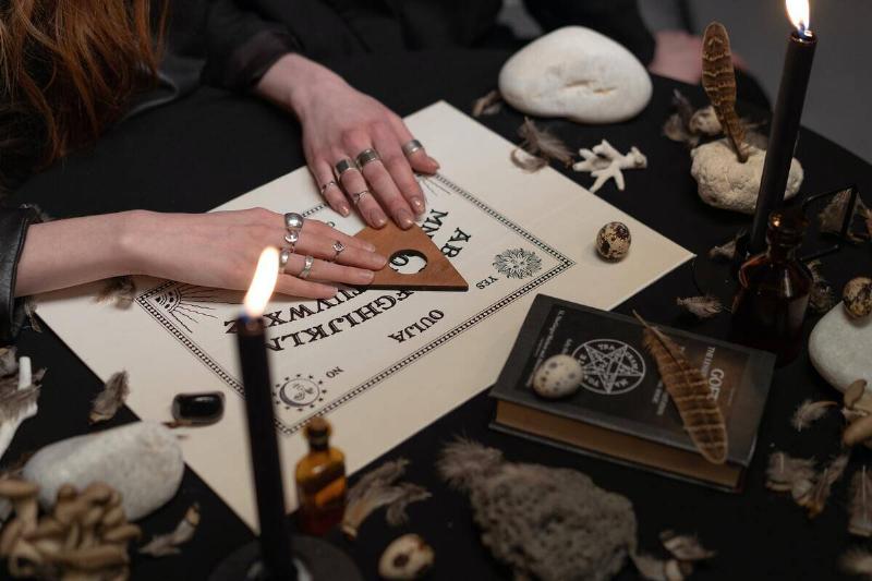 A woman using a ouija board.
