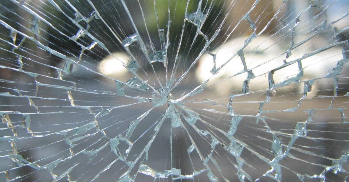 A shattered windowpane, still intact but full of cracks.