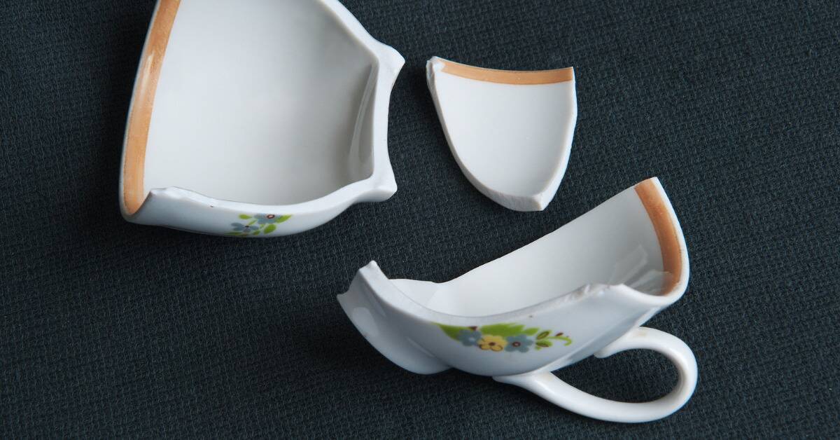A teacup that's broken into three clean pieces.