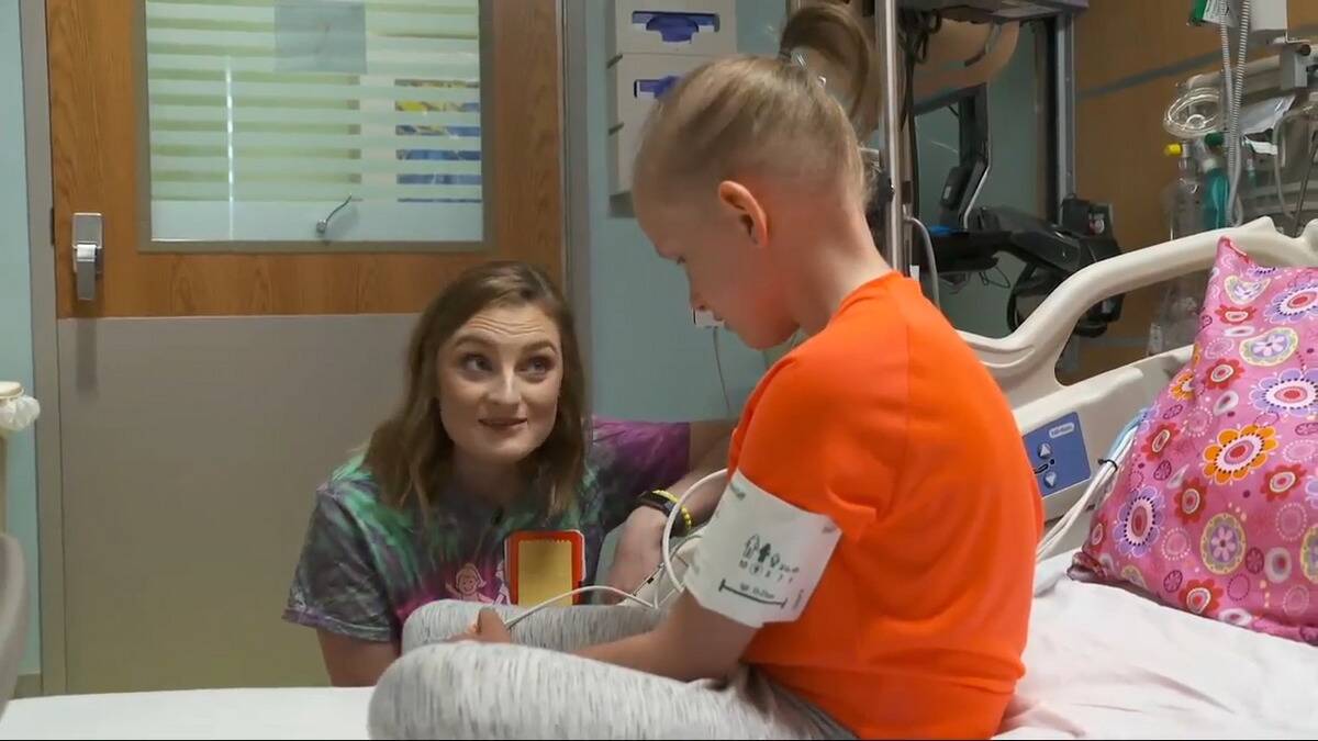 Brown speaking to a young patient of hers.