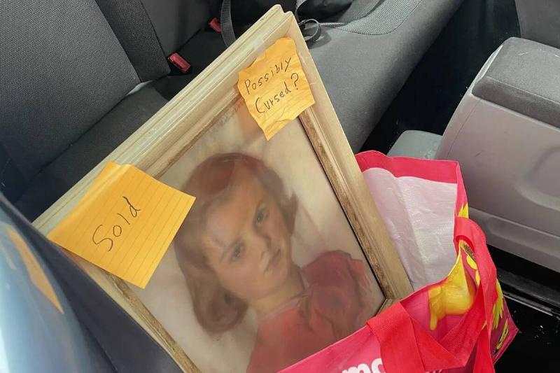 The painting in a shopping bag in the back seat of Zoe's car.