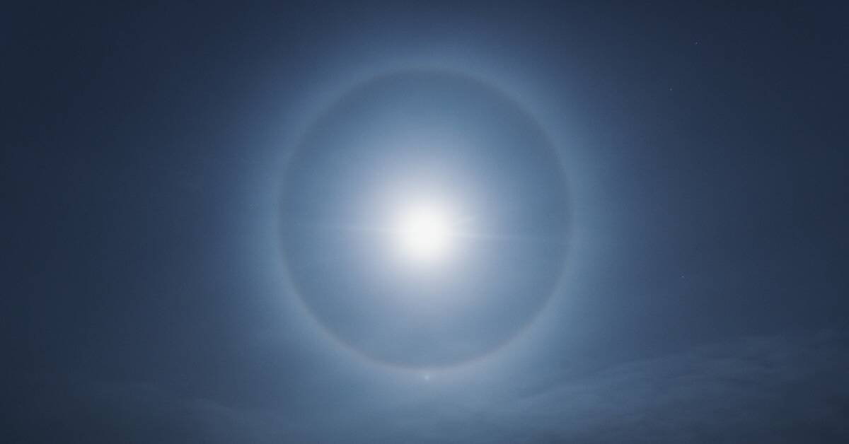 A lunar halo against a blue sky.