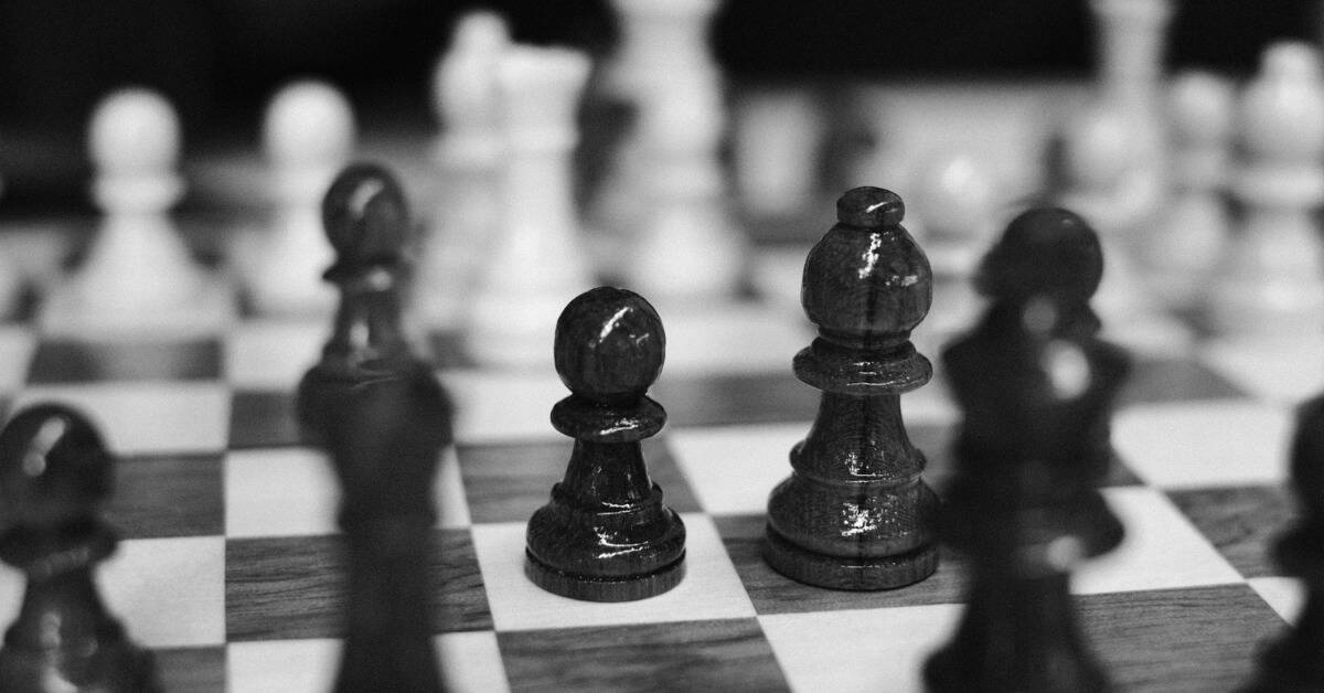 A greyscale image of chess pieces on a board.