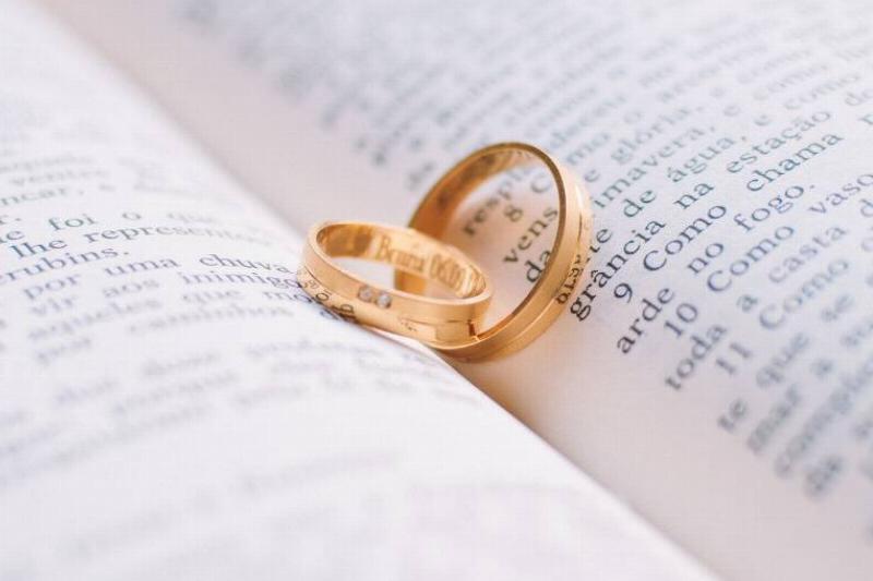 Two wedding bands posted in the center crease of a book.