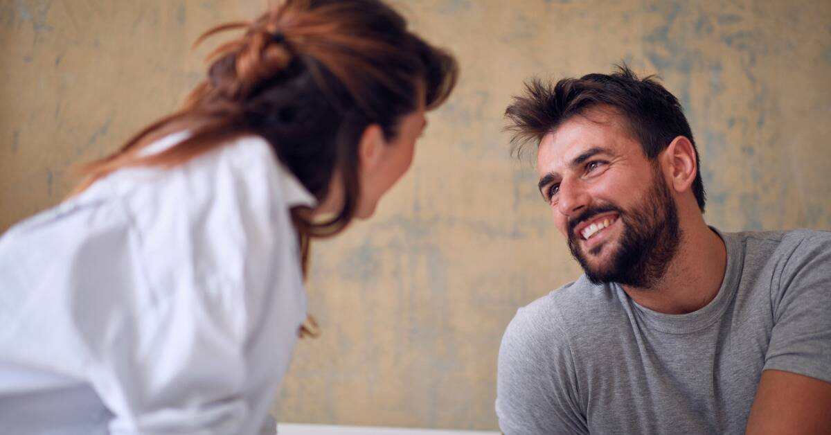 A man looking lovingly at his girlfriend.