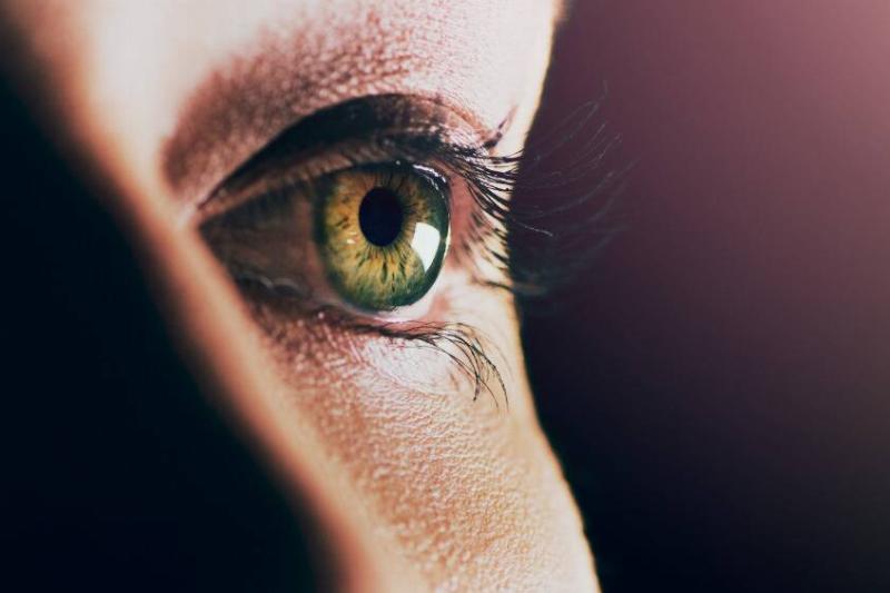 A closeup of someone's green eye.