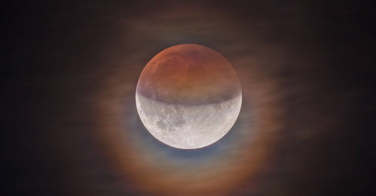 A partially eclipsed moon hanging in the sky.