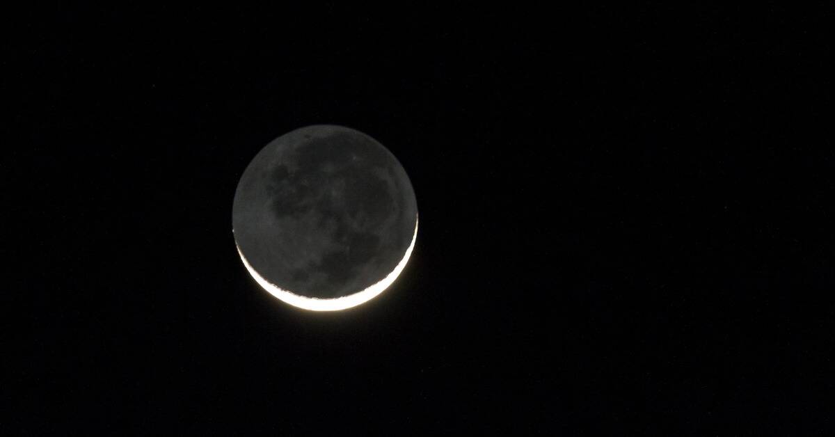 A crescent moon in a dark sky.