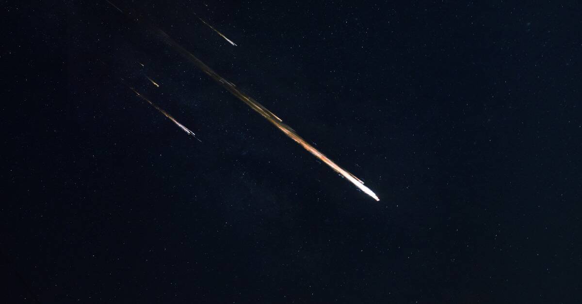 A bright meteor visibly flying across the sky.