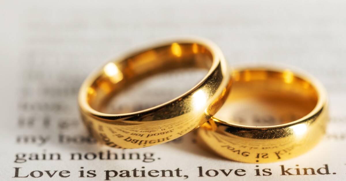 Two wedding bands posed together on top of some text that reads, 