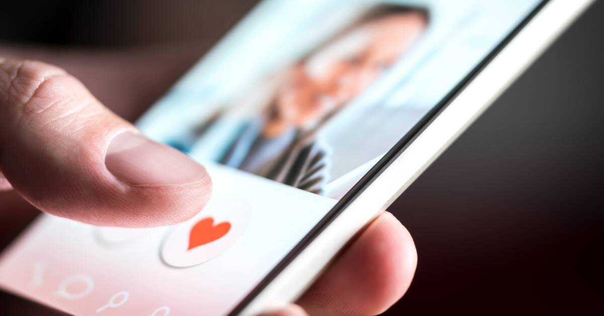 A closeup shot of someone swiping a profile on a dating app.