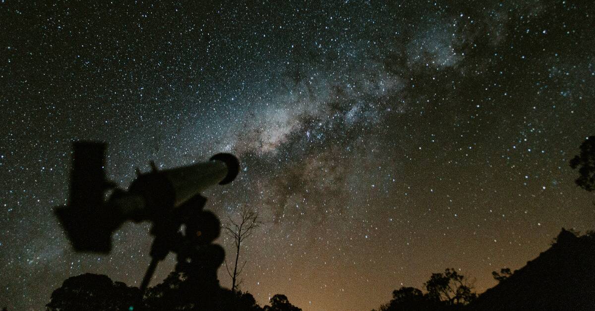 A standard telescope pointed at a very starry sky.