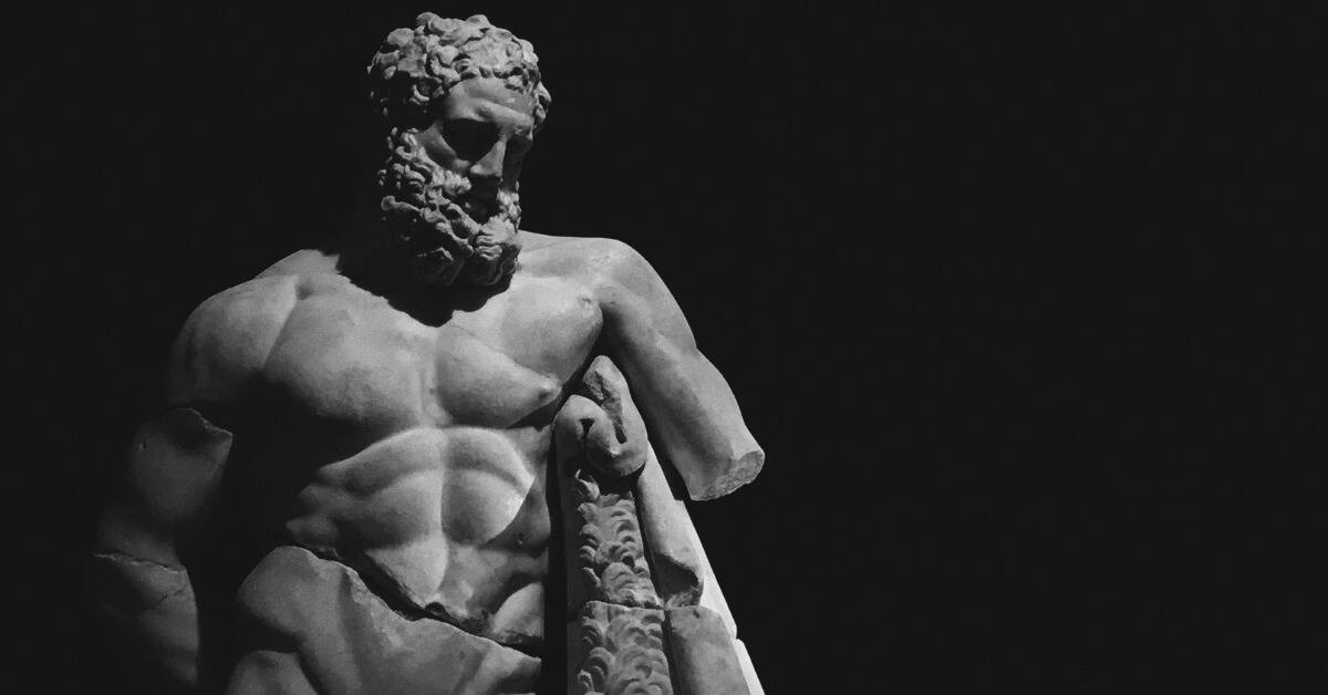 A Greek statue lit in stark shadow.