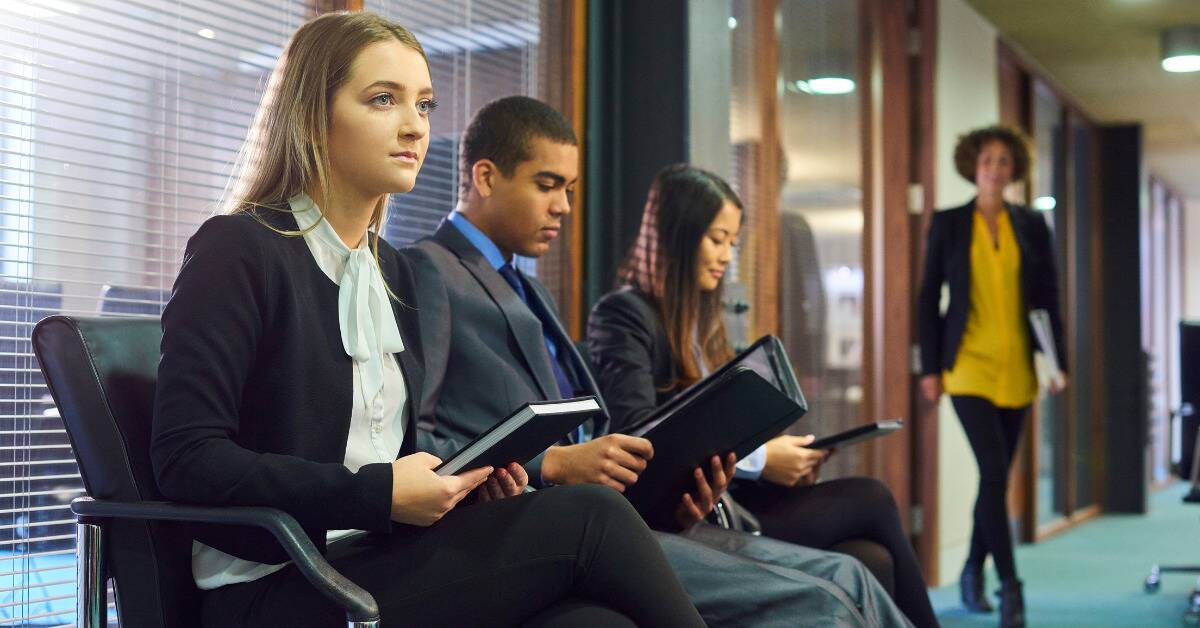 Three people sat down for a job interview, with one woman looking more nervous than the other two candidates.