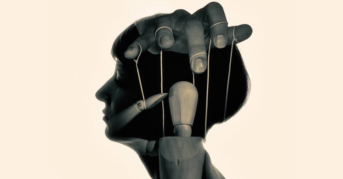 The silhouette of a woman's head with the image of a hand controlling a wooden marionette superimposed in it.