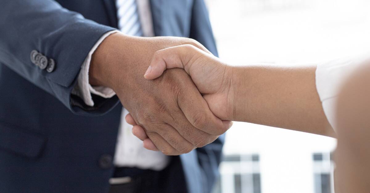 A close shot of two people shaking hands.