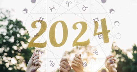 Hands holding up gold numbers that spell out 2024. There's a semi-transparent astrological wheel superimposed on top.