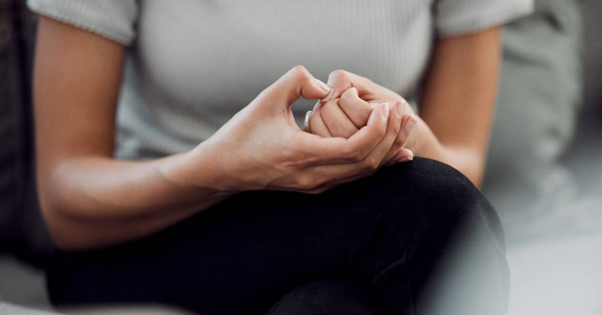 A close shot of someone's hands being wrung in an anxious manner.