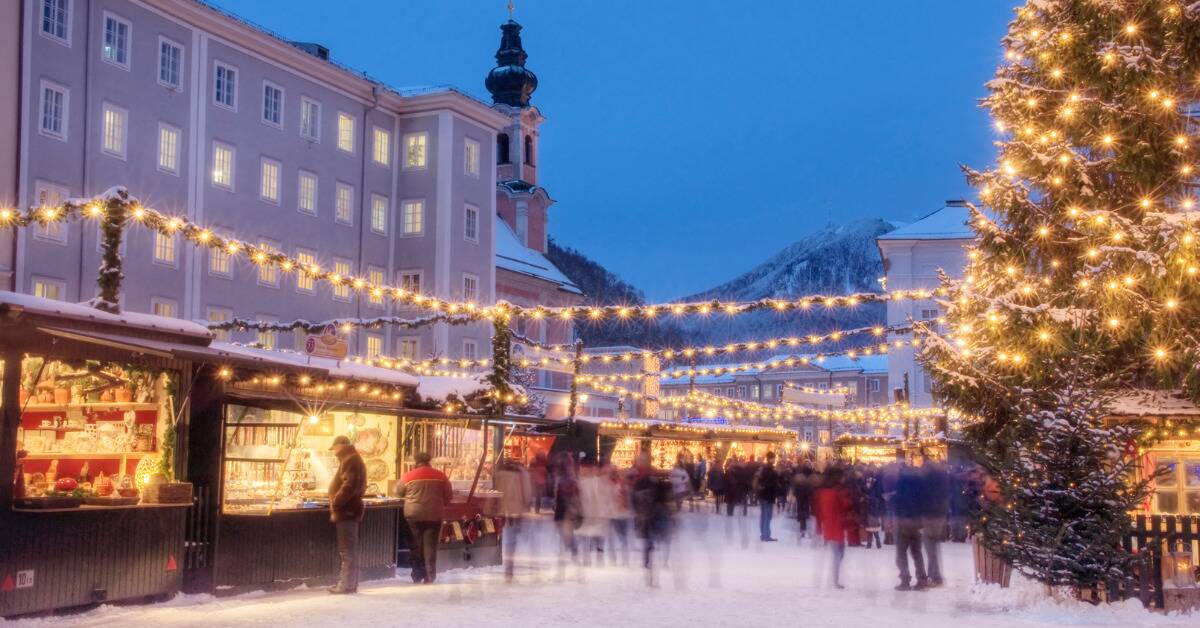 A time-lapse photo of an outdoor Christmas market.