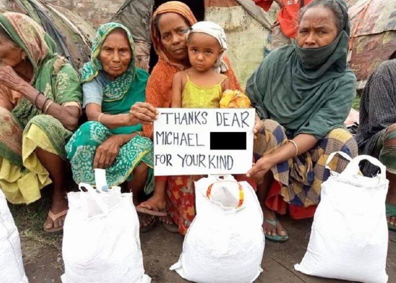 One of the photos from Bangladesh that Michael received of some citizens with bags of food holding a sign that reads, 