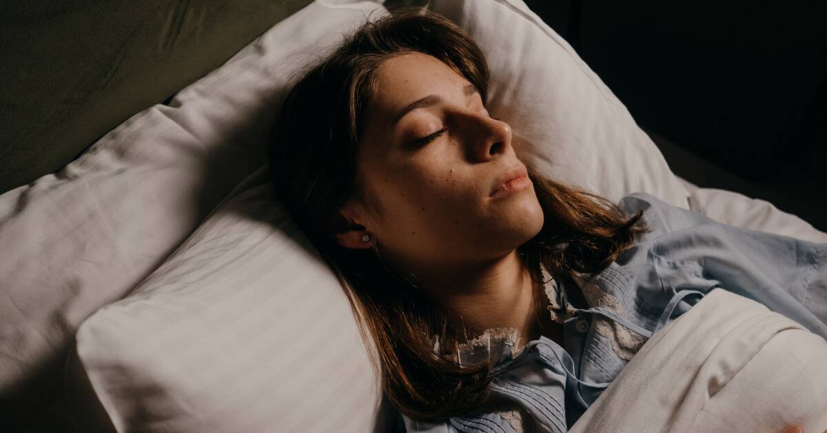 A woman asleep in bed.