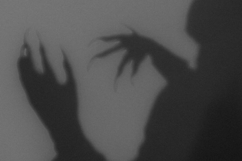 A shadowy creature with clawed hands.