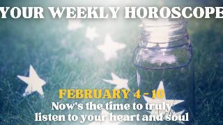 A jar with paper stars in and surrounding it in some grass. There's text that reads, 