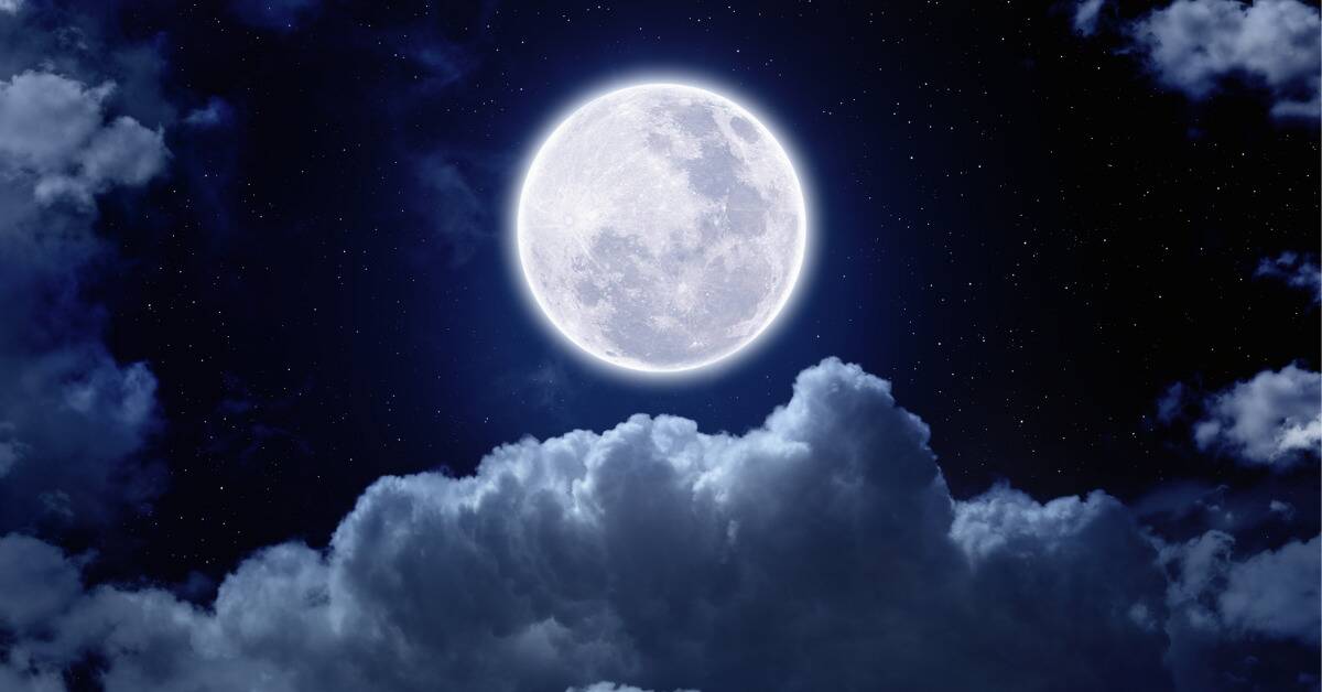 A render of a bright full moon above the clouds in the night sky.