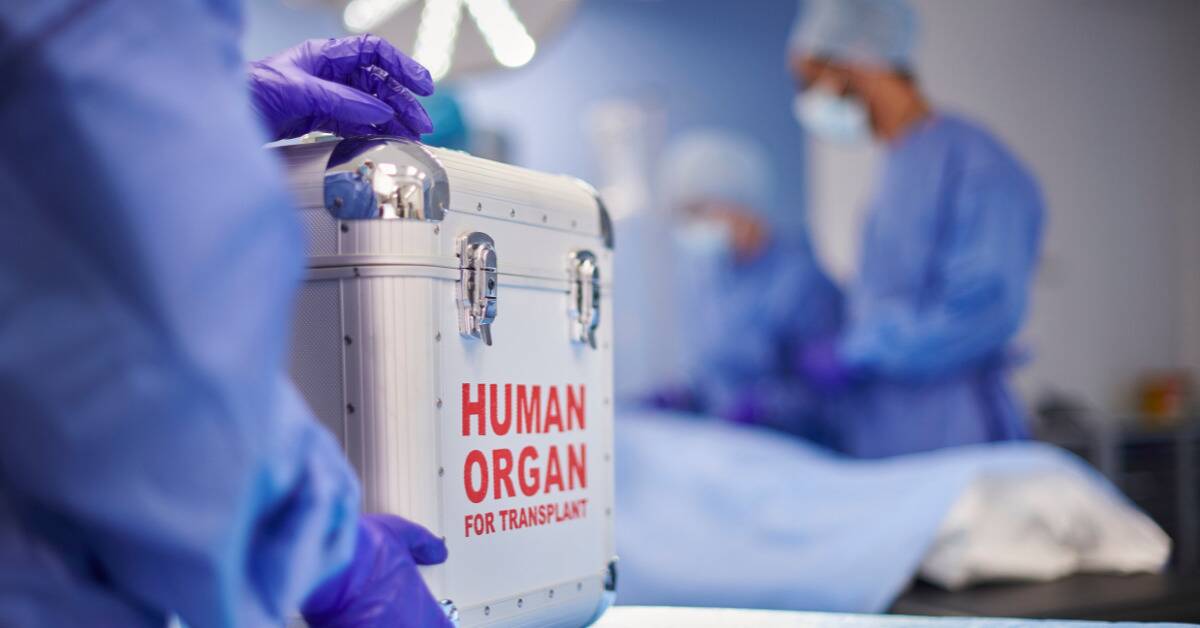 A hospital operating room, nurses in doctors in full-coverage scrubs blurry in the background, with the camrea focus being on the case with bold red lettering that reads, 