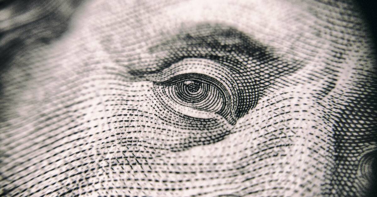 A closeup of Benjamin Franklin's eye as it's printed on American bills.