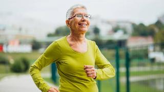 A woman cheerfully walking outside.