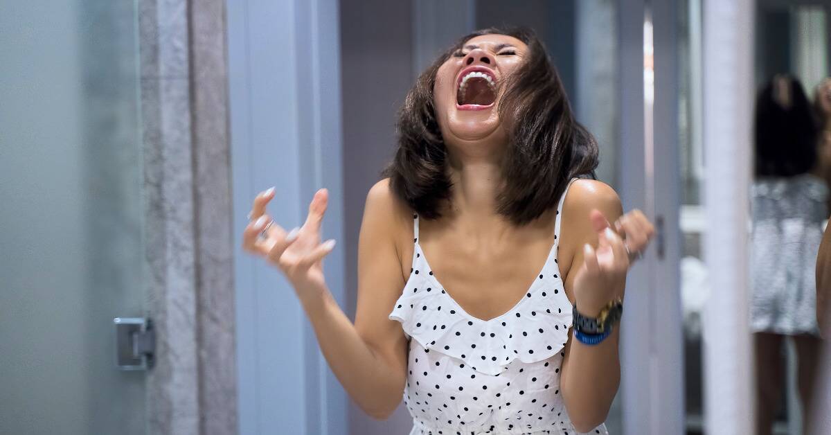 A woman yelling in frustration.