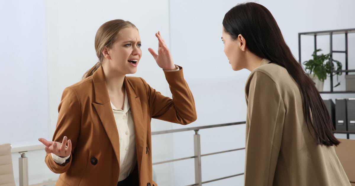 A woman speaking angrily to a friend.