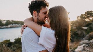 Couple closeup to each other about to kiss.