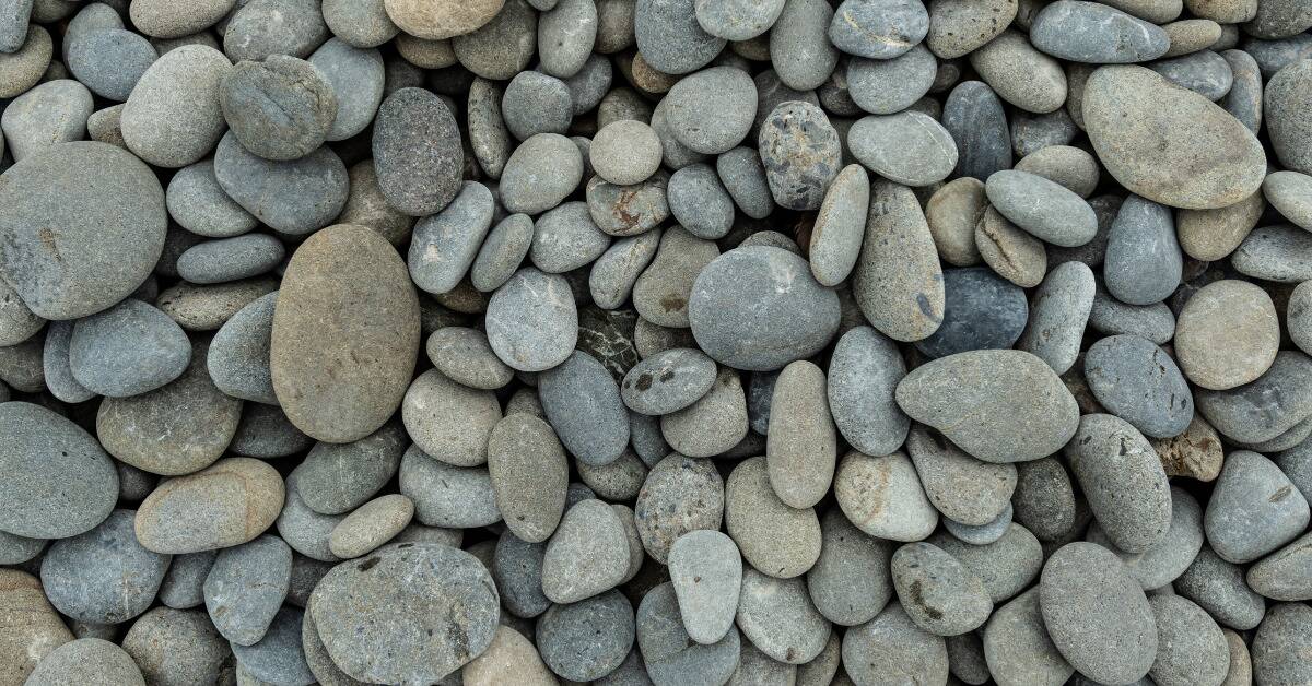 A photo of small, round, grey rocks.