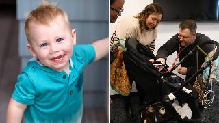 A photo of Beau smiling and looking directly at the camera. | Rob listening to Eli's heartbeat with a stethoscope, Jenny also standing over the stroller to watch.