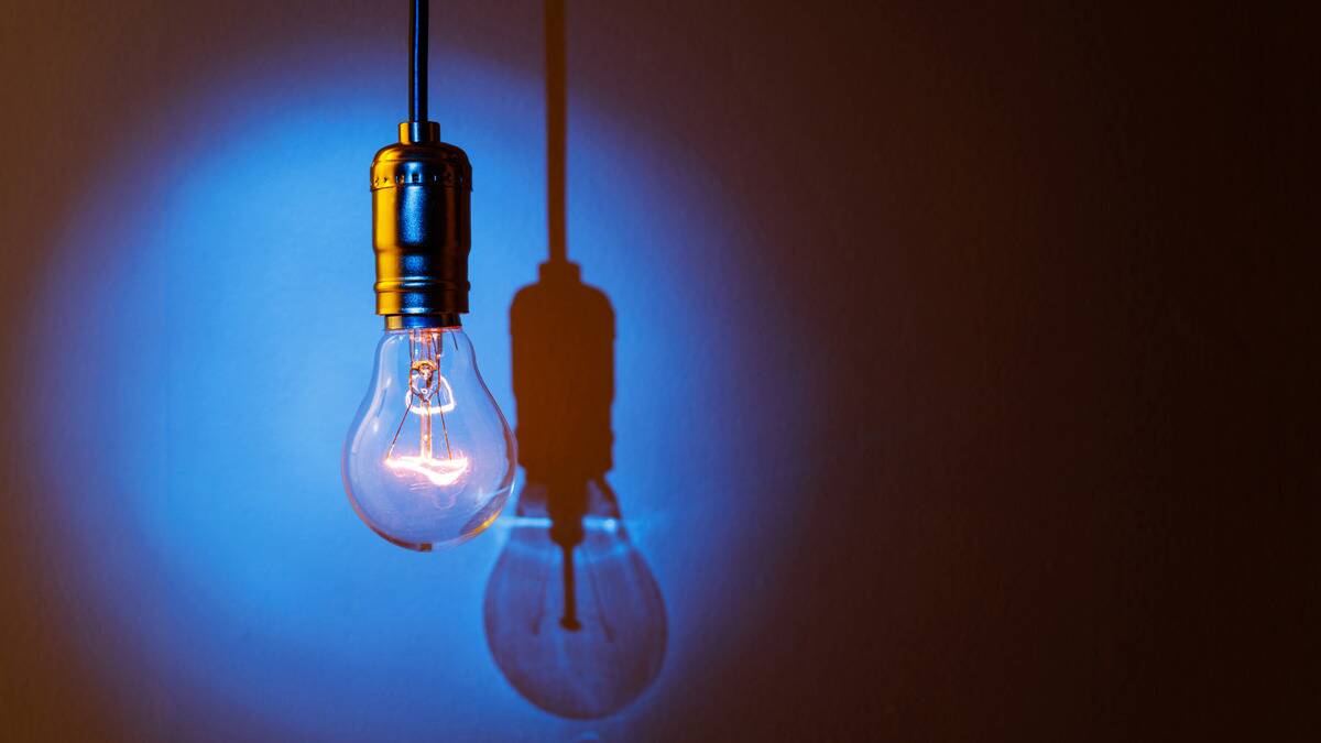 A light bulb turned on, a blue spotlight being shined on it.