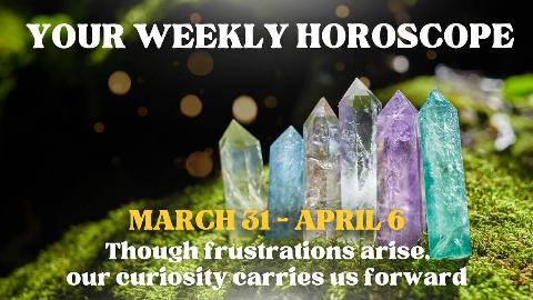 Some colorful, carved crystal pillars atop a mossy rock, arranged in a line. There's text that reads, 