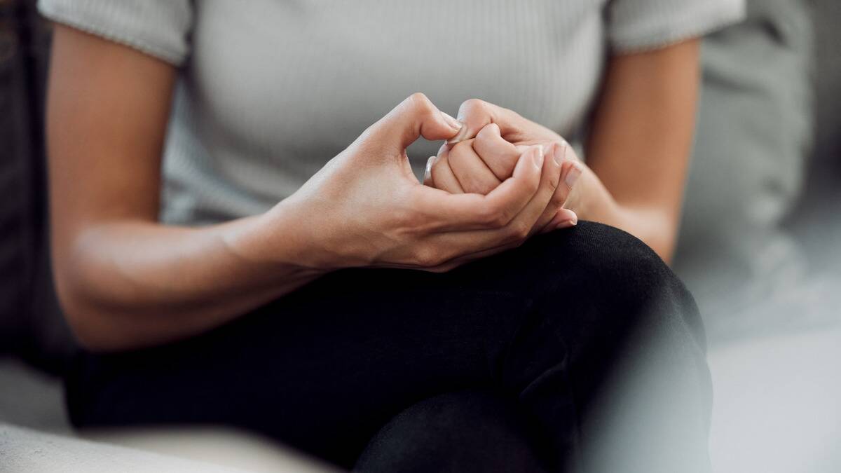 A close shot of a woman's hands that are fidgeting anxiously.